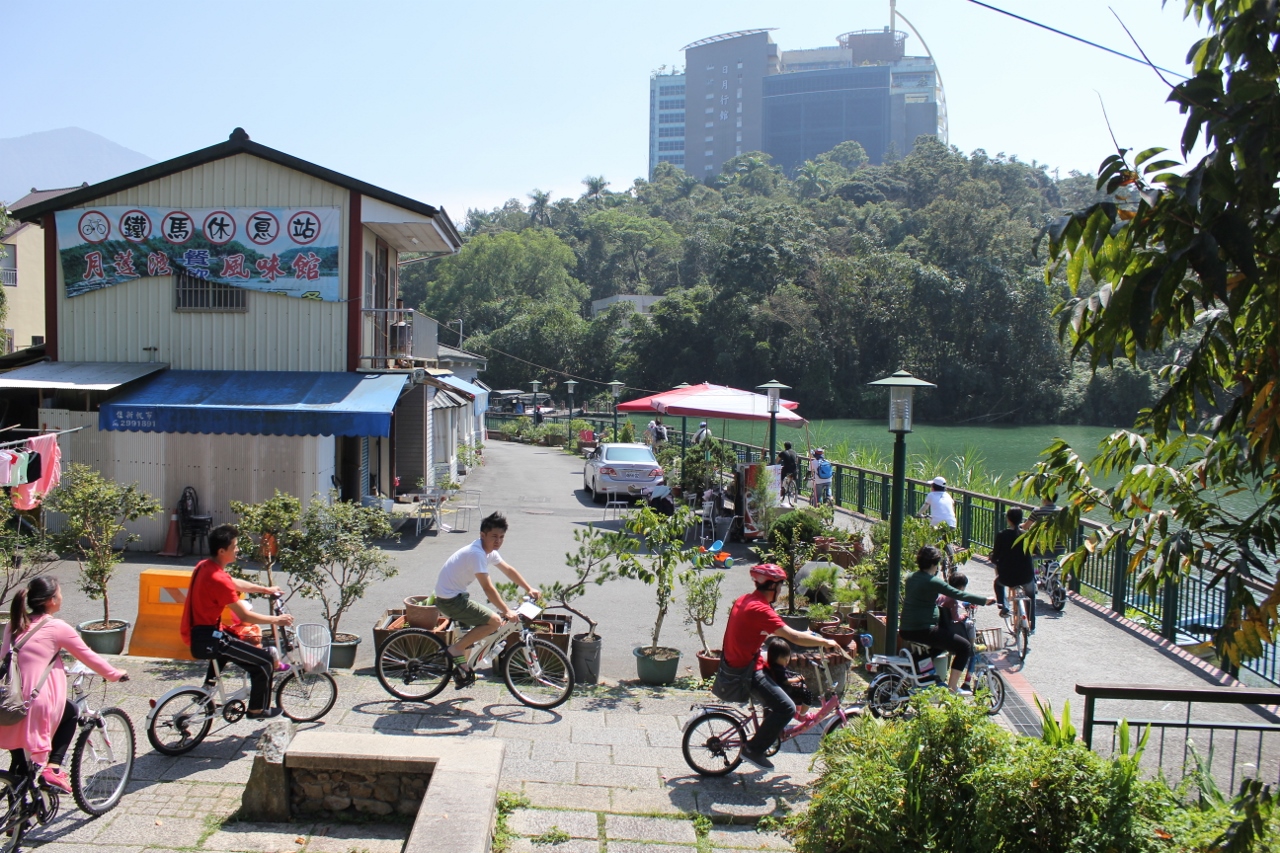 People on bicycles around the lake edge